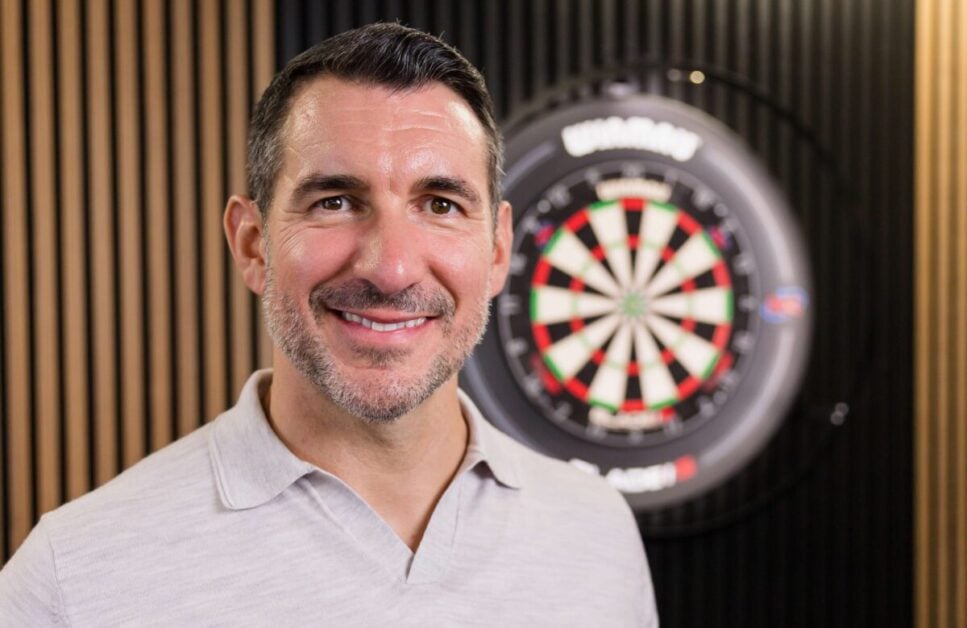 Tom Brown poses with a Winmau darts board