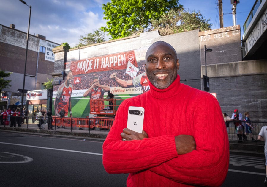 Sol Campbell standing in front of Arsenal mural